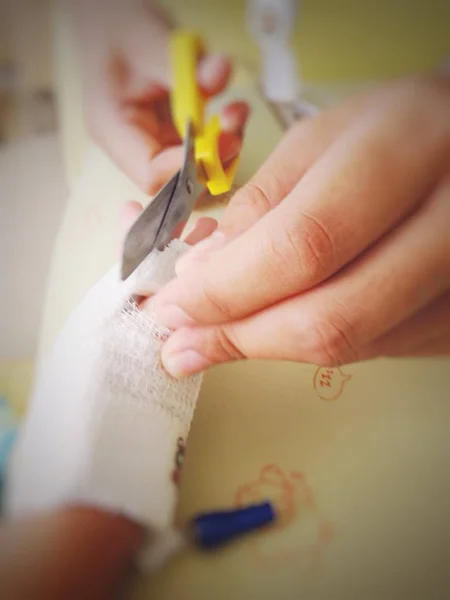 Nurse cut gauze for removing saline needle