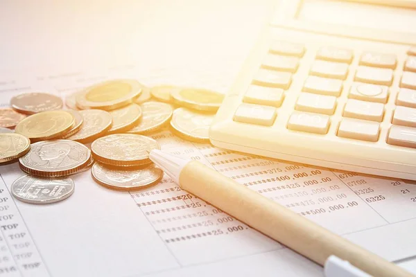 Coins, pen, calculator and savings account passbook on white background