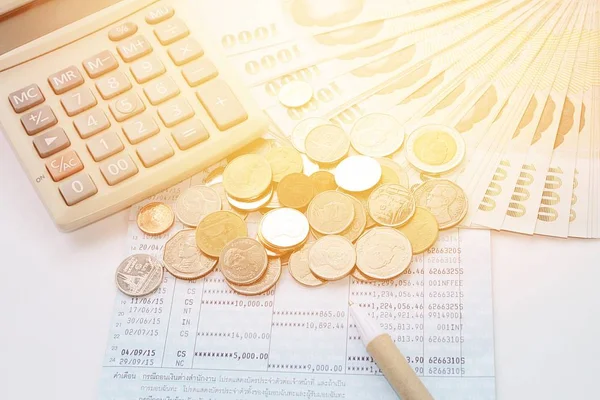 Coins, Thai money, pen, calculator and savings account passbook on white background — Stock Photo, Image