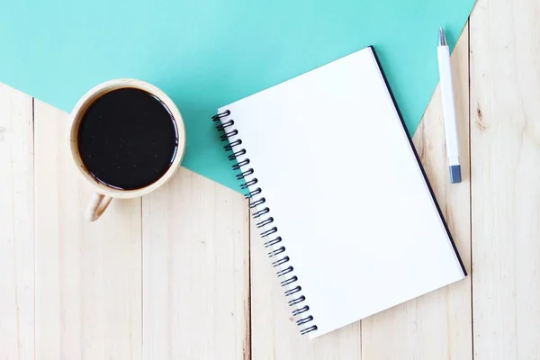 Top view image of open notebook with blank pages and coffee cup on wooden background, ready for adding or mock up — Stock Photo, Image