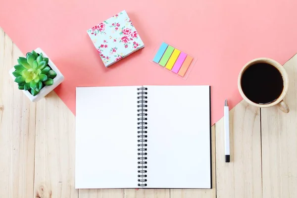 Top view image of open notebook with blank pages, accessories and coffee cup on wooden background, ready for adding or mock up — Stock Photo, Image