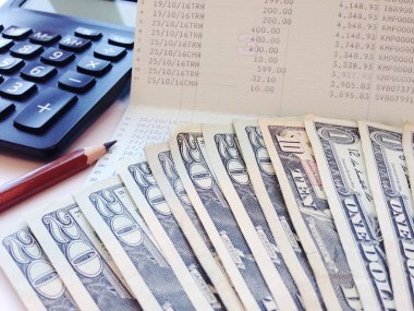 İş, finans, yatırım veya muhasebe kavram: dolar para, hesap makinesi ve Ofis Masası üzerinde hesap kitap ya da mali tablo kaydetme