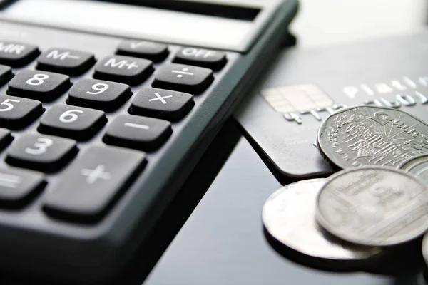 Кредитна картка, калькулятор і монети на офісному столі — стокове фото