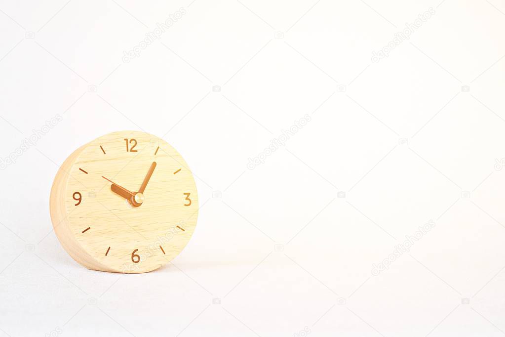 Wooden alarm clock on white background