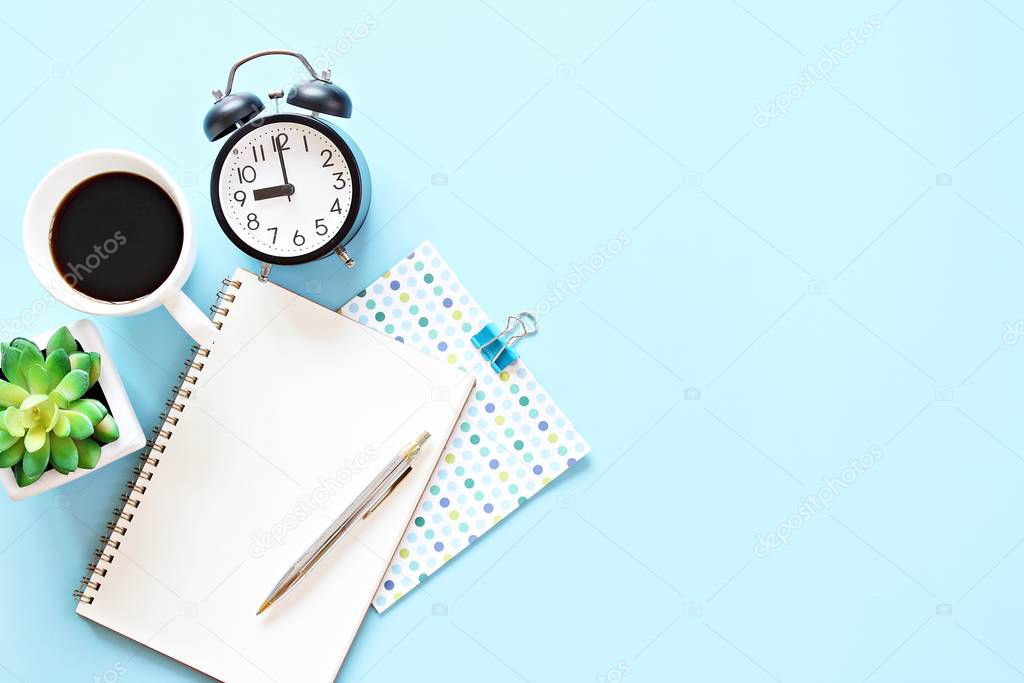 Still life, business, office supplies, working day, meeting, education, work from home concept : Notebook, clock, pen and coffee cup on blue background with copy space ready for adding or mock up