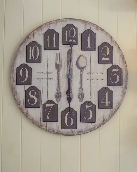 Une horloge murale sur fond de papier peint en bois — Photo