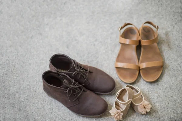 Father mother and Daughter shoes on concrete