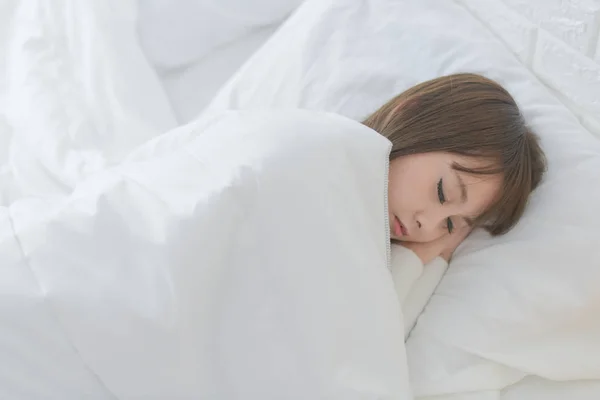 Young beautiful asian woman are happy lying in bed, Beautiful asian girl are sleeping comfortably in bed and don't want to wake up in her bedroom, morning concept