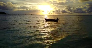 Günbatımında denizde sallanan yalnız bir tekne. Jamaika, Karayipler 'de yaz tatili.