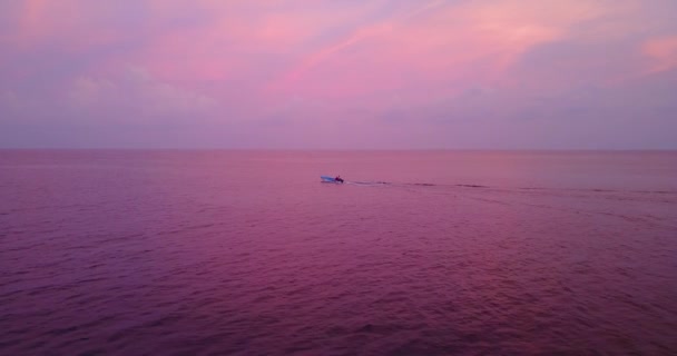 在南亚马尔代夫 在粉色落日的海景下 白色的船在蓝色的海面上航行的空中镜头 — 图库视频影像