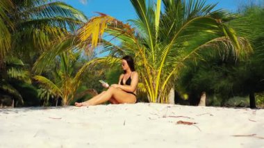 Siyah mayo giyen, plajda güneşlenen yaz tatili konsept görüntüler. 