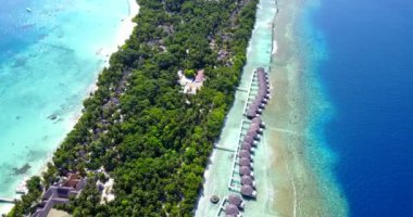 Su bungalovlarının üzerindeki egzotik adanın insansız hava aracı görüntüsü. Fransız Polinezyası 'nda Tahiti' de yaz tatilleri.