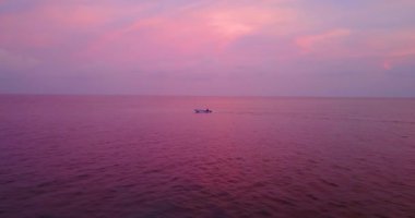 Colourful dusk by the seaside. Journey to Gili Trawangan, Thailand.