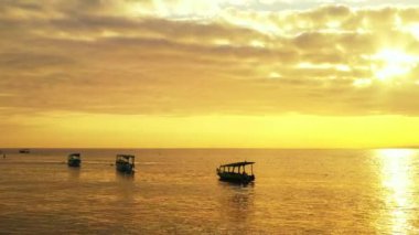 Altın saat boyunca rıhtımlı teknelerle parlak sarı gün batımı. Tayland, Asya 'da yaz tatili.   