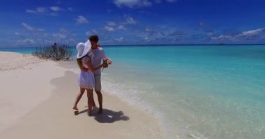 Karayip adasında yaz tatilindeki balayı çifti. Turkuaz deniz ve altın kumsal arka planı.