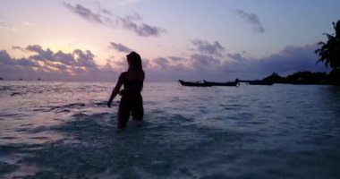 Geceleri denizde yüzen siluet kız görüntüleri.