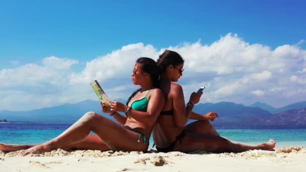 Two Girls Having Nice Time Talking Reading Brochure Sandy Beach — Stock Video