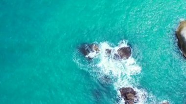 Waves breaking at the boulders. Journey to Gili Trawangan, Thailand. 