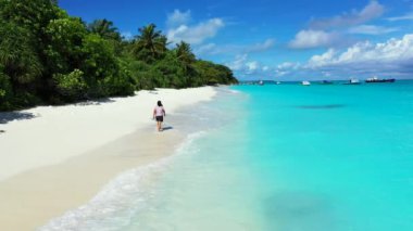Aerial view, summer colorful seascape, amazing tropical curve beach. Beautiful woman walking on paradise sandy seaside.