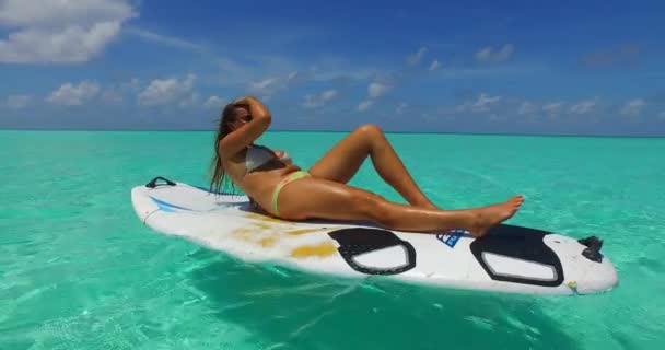 Vídeo Chica Atlética Tomando Sol Tabla Surf Balanceándose Sobre Las — Vídeo de stock