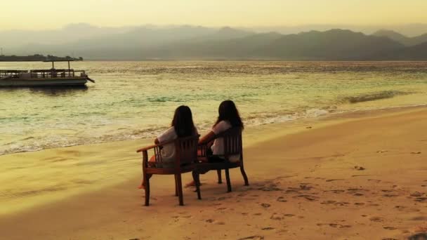 Dwie Dziewczyny Siedzące Piaszczystej Plaży — Wideo stockowe