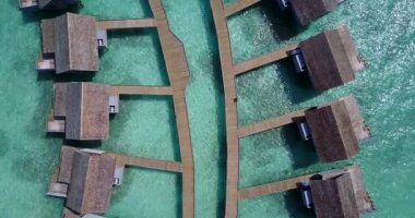 Flying above island with cozy wooden bungalows. Journey to Gili Trawangan, Thailand.