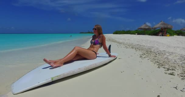 Woman Bright Colourful Bikini Relaxing Surfboard Seashore Maldives — Stock Video