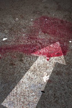 Conceptual image of a blood on the street pavement.  clipart