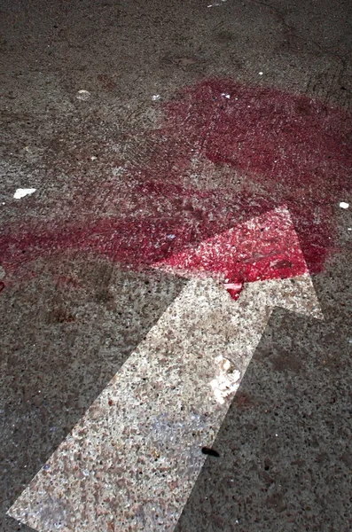 Conceptual image of a blood on the street pavement. — Stock Photo, Image