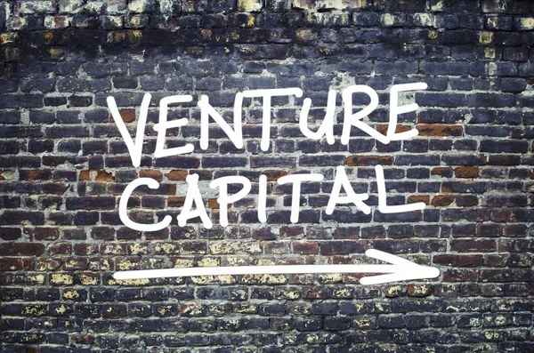 Venture capital text on brick wall