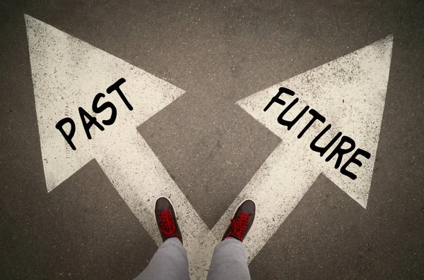 Sneakers standing on a road with arrows, Future or Past Decision — Stock Photo, Image