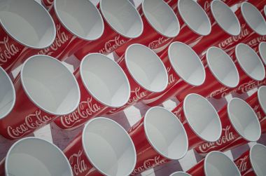 Coca Cola water cups for marathon runners on refreshment point.  clipart