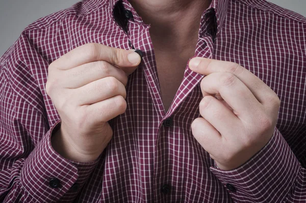 A man wearing buttons shirt close up