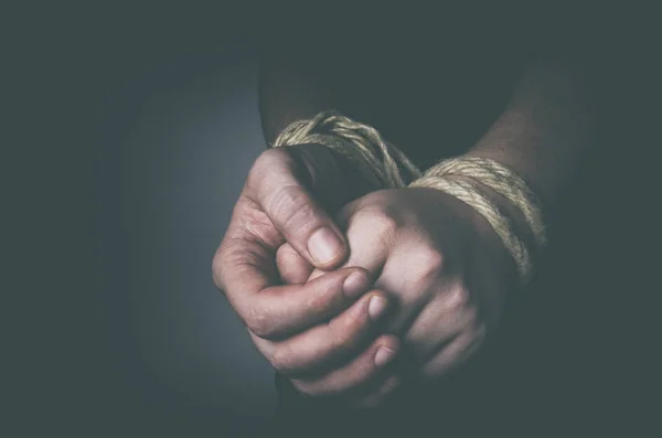 Man with tied hands in low key — Stock Photo, Image