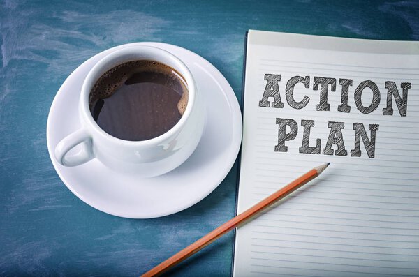 Action plan concept on a notebook with cup of espresso coffee