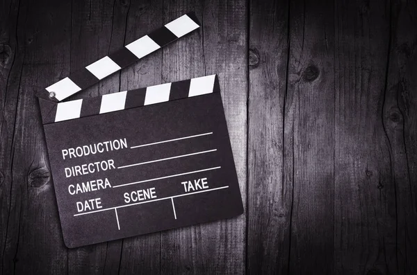 Movie clapper board on wooden background — Stock Photo, Image