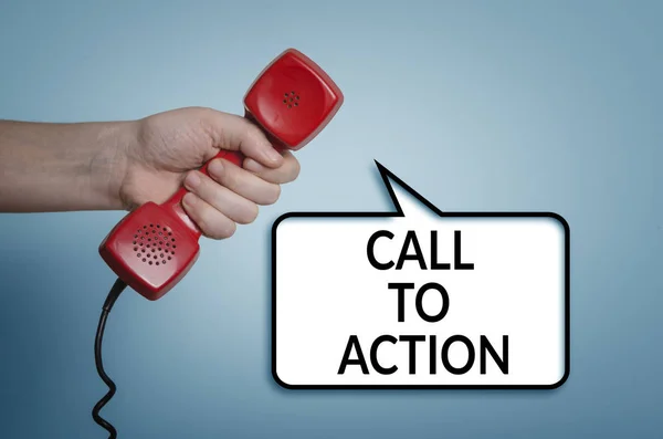 Call to action concept with red phone in hand