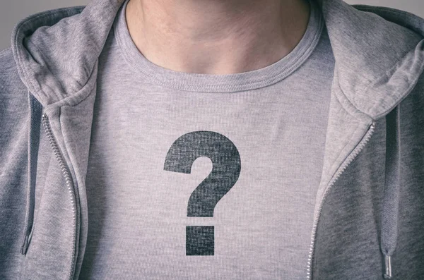 Boy with question mark on T-shirt. Conceptual image of confusion and identity issues. — Stock Photo, Image