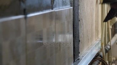 Duvardaki seramik yapıştırıcı koyarak