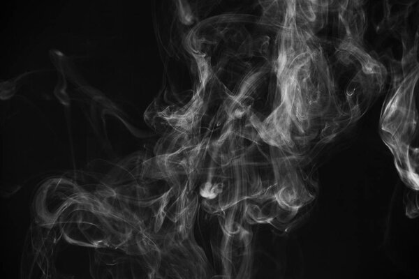 Movement of white smoke.black background. Smoke from cigarettes. Vape
