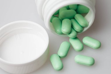 hap ve beyaz zemin üzerine hap şişesi