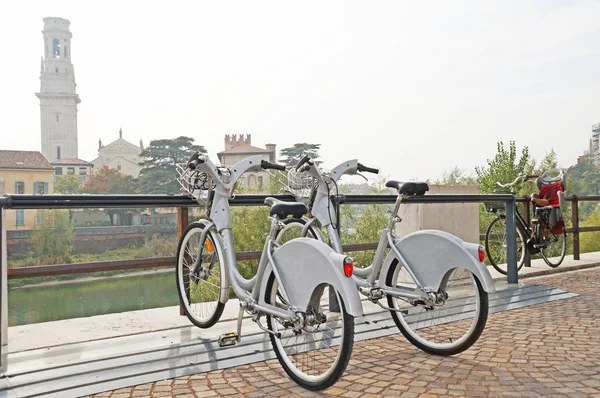 Verona is a city of bicycles. Two bicycles is parked in a beautiful city. Bicycle on the background of the cityscape.