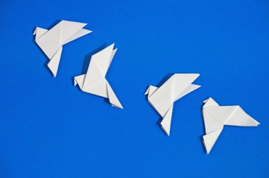 Origami güvercinler üzerinde mavi arka plan izole.
