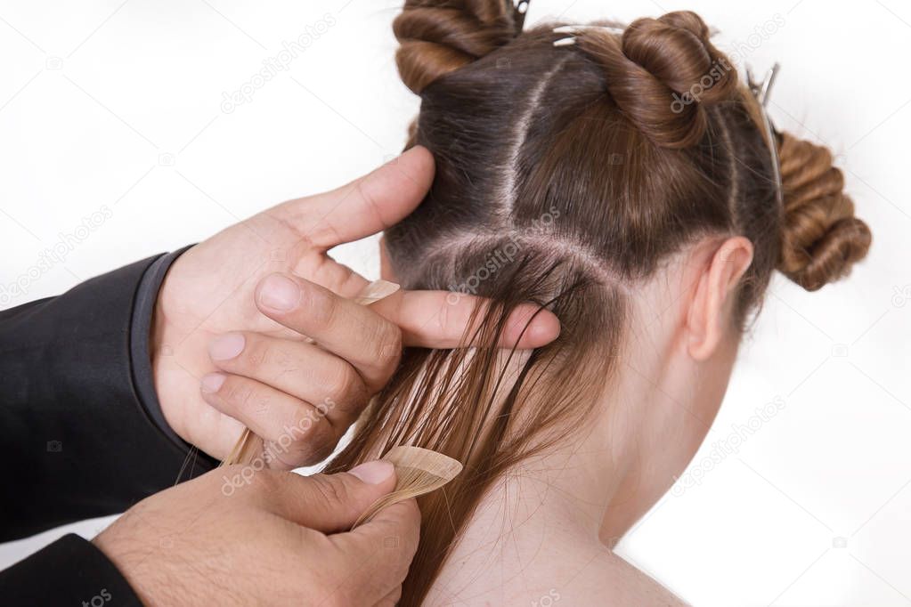 Natural Hair extensions at salon, closeup hands in hair