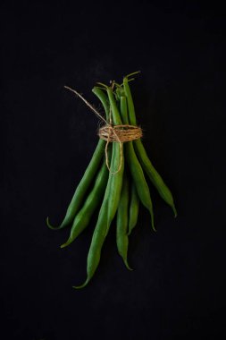 Green string beans on a black background. Healthy organic food collection. Copy Space for Text. clipart