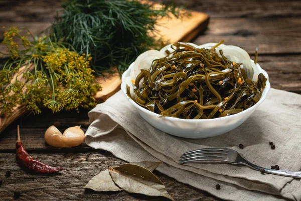 Pickles on a dark wooden table with light textile and a cutting wooden board — Stock Photo, Image