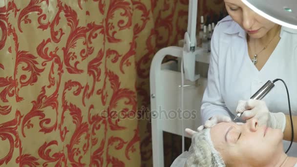 Schoonheidsspecialist maken van permanente make-up op dames gezicht — Stockvideo