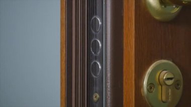 Elinde anahtarla kapıyı kilitlemek ya da açmak.