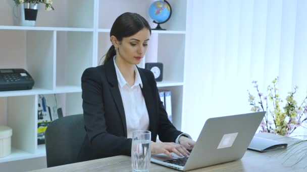 Young beautiful businesswoman drinking water at work — Stock Video