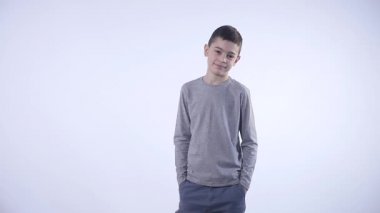 Kameraya bakan sevimli, genç ve mutlu bir çocuğun fotoğrafı.